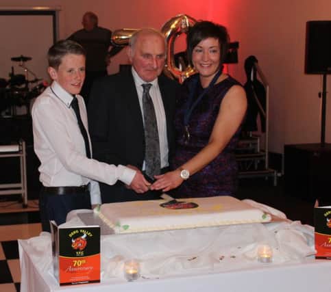 Cutting of the cake - Oldest member Ual Carson, along with youngest current member Craig Keatley and YFCU President Roberta Simmons