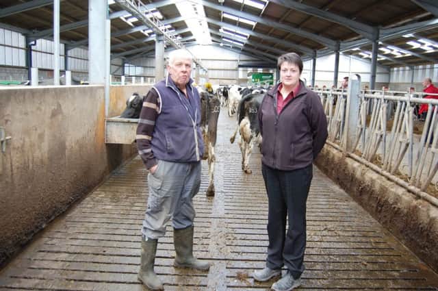 Moore Concrete's Keri McGivern is pictured with Alan Hoy at Hollybank Farm , Parkgate. The farm is currently home to 70 Holstein cows that are housed in a new cubicle shed and milked by a DeLaval robot. Moore Concrete's Surefoot slats were used throughout the new house.