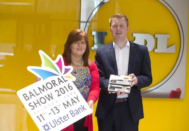 Jenny McNeill, RUAS and Paul Gibson, Sales Operations Executive, Lidl Northern Ireland celebrate as Lidl sponsor Car park signage and Hereford cattle section at Balmoral Show 2016.