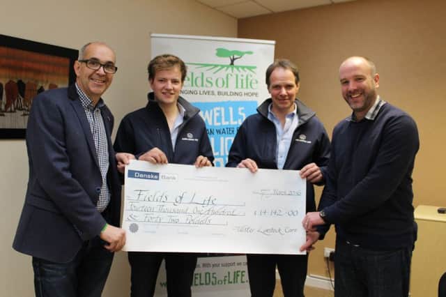 Dessie and Caleb Howard present a cheque for Â£14,142 to Fields of Life CEO, Richard Spratt and Fields of Life Trustee, Angus Wilson (from left to right  Angus Wilson, Caleb Howard, Dessie Howard and Richard Spratt