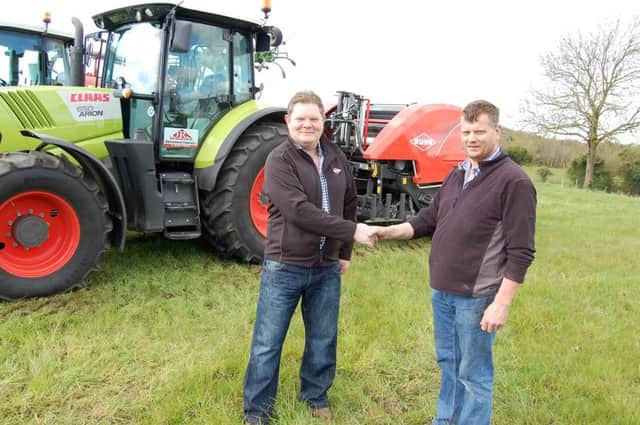 Thomas Dilly (right)  receives his new Kuhn IB10 baler from Stephen Bloomer, representing D & S Logan, Cullybackey