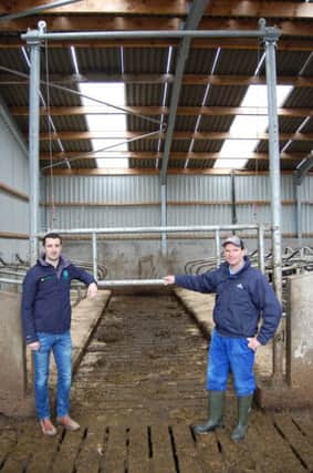 Teemore Engineering's  Fergal Quinn (left) and Banbridge milk producer George Mitchell standing in front a new guillotine gate