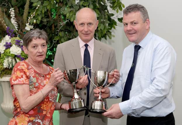 Daphne Orr and Edwin Cartwright, office adminstrator and secretary of the Tyrone Farming Society respectively and vice-chairman Thomas Harkin with the new John Devine Memorial Cups to be presented to the champions in the North Country Cheviot and Hill Cheviot classes.Jmac-21