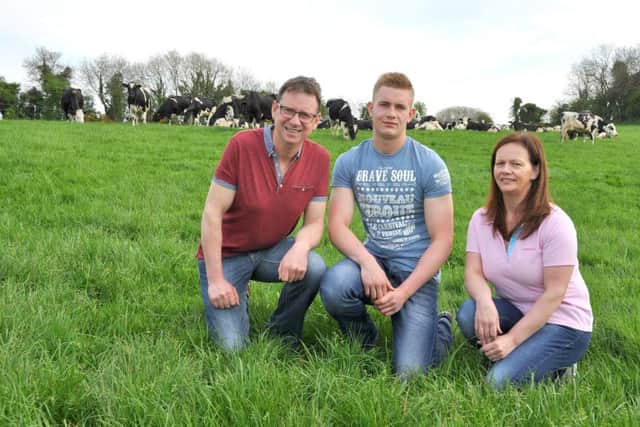 Adrian McFarland, left, and wife Sharon with son Ryan on their farm near Omagh. Picture: Chris McCullough