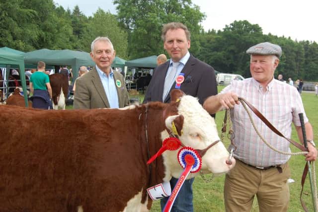 Judge Anders Mortensen (centre) from Denmark, congratulates Mervyn Richmond (right), from Co Fermanagh on winning the Hereford championship at Armagh Show 2016 with an excellent heifer. Adding his congratulations is Co Armagh Hereford breeder Robin Irvine.