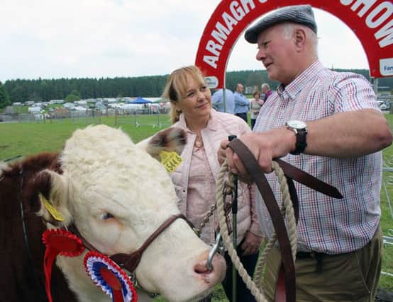 Agriculture Minister Michelle McIlveen chats with Co.Fermanagh farmer Mervyn Richmond after winning the Hereford Championship at the Armagh Show on Saturday 10 June 2016. Photo Louise Millsopp
