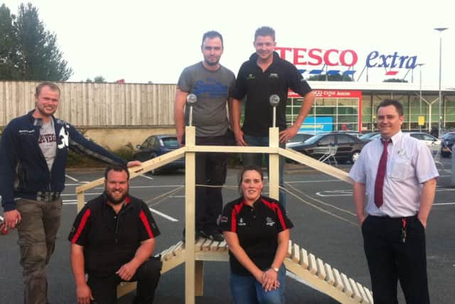 Winners of the Co Antrim heat of the Build It competition, Kilraughts YFC with judge Robert Shaw (left) and a Tesco representative