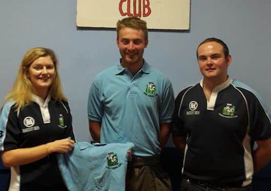 Assistant club leader Rebecca Orr and club leader David Young presenting club shirts to Matthew Patterson for his exchange