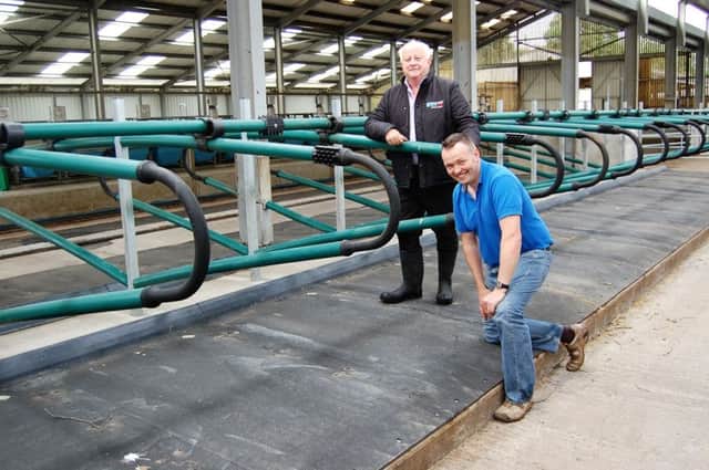 Lyons' Estate farm manager Dr Eddie Jordan and EasyFix's P J Burke (standing) in the new dairy unit at the UCD farm