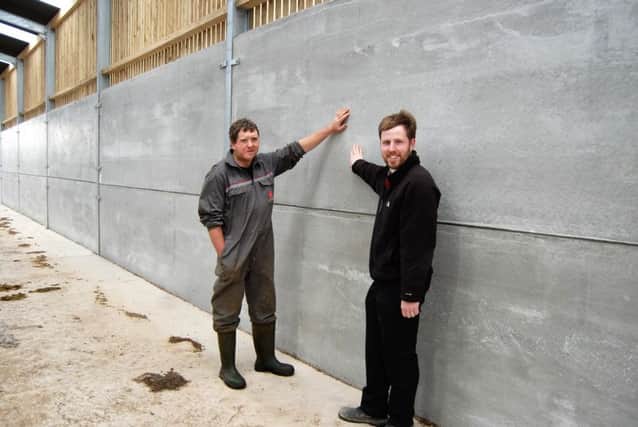 Doagh dairy farmer Johnny Coleman (left) discussing the pre-stressed wall panels used in the farms new cubicle shed with Moore Concretes Jeff Haslett