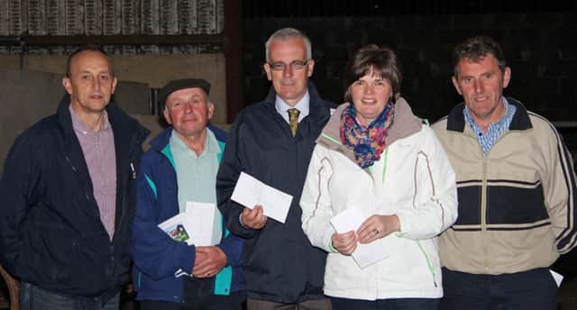 Ivan Minford, AI Services (NI) Ltd, congratulates winners of the open stockjudging class, Henry Thompson and Lynda Fleming, joint first;  John Henning and Laurence Hamill, joint second.