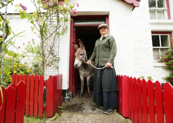 Pictured is Ginny the traditional Irish donkey and Ulster Folk & Transport Museum visitor guide Pamela Marshall.