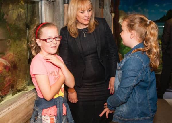 Minister Michelle McIlveen chats with Kieva and Lara from Portaferry during her visit to Exploris Aquarium