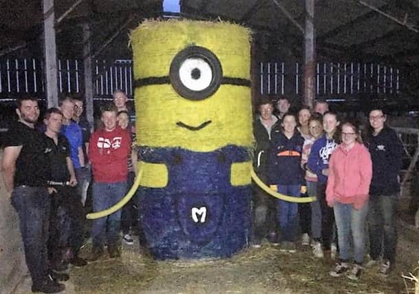 Members of Moneyrea Young Farmers' Club and Killinchy Young Farmers' Club with their bale art