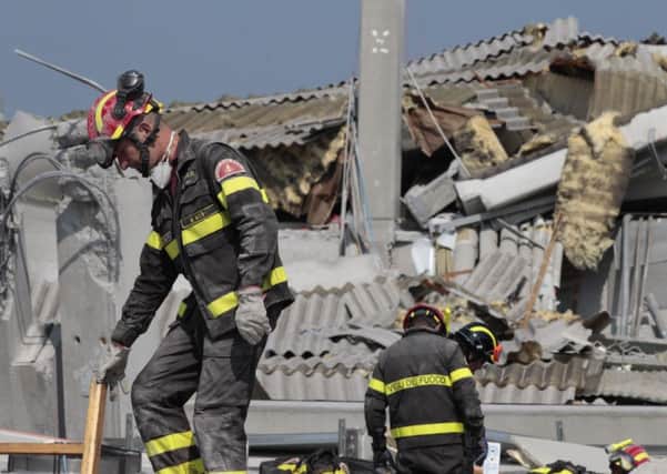 Italian firefighters work amid debris of a collapsed factory in Medolla, Italy, Wednesday, May 30, 2012. A magnitude 5.8 earthquake struck Tuesday that felled old buildings as well as new factories and warehouses in a swath of Italy north of Bologna. The quake, which followed a May 20 magnitude-6.0 quake in the same area, dealt another blow to one of the country's most productive regions at a time when Italy is struggling to restart its economy. (AP Photo/Gregorio Borgia)