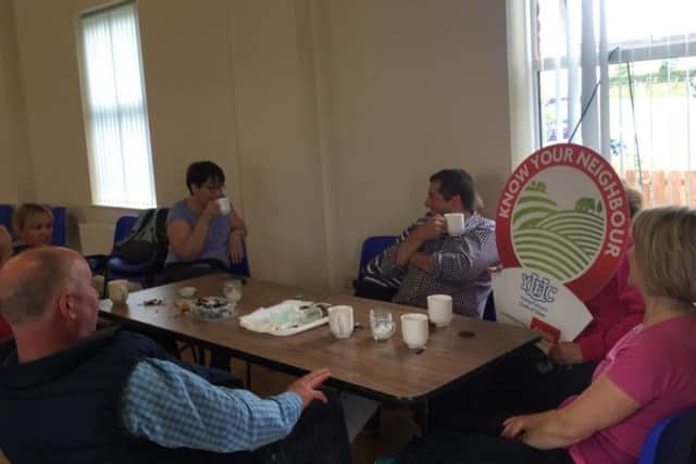 The older generation enjoying a catch-up over a cup of tea during the Holestone YFC Know Your Neighbour' sports day
