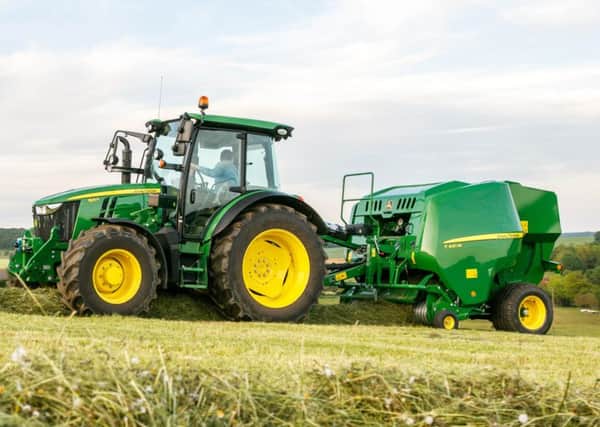 A new 5125R tractor from John Deere with baler attachment