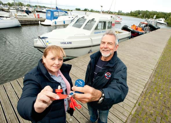 DAERA Minister Michelle McIlveen hands over the keys of the Vigilare to Billy Mullen, patron of Lough Neagh Rescue. The former fisheries patrol vessel, which has been replaced by a more modern boat, was offered to groups in the Lough Neagh area which could use it for the good of the community. Once refitted, the Vigilare will become a command vessel for Lough Neagh Rescue and help to save lives on the Lough.