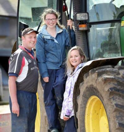Dairy farmer Roger McCracken, from Ballywalter, with third year medical students Katherine Aiken, from Randalstown, and Ruth Jenkins, from Ballyclare.