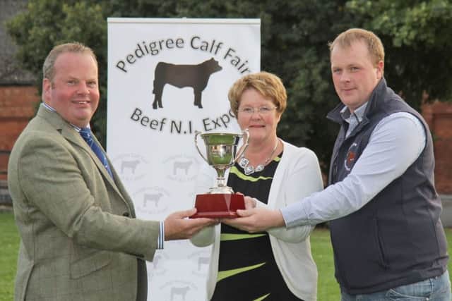 Denise Bailie, and son Uel, Dromara, present the Croobview Cup to Pedigree Calf Fair @ Beef NI Expo chairman David Connolly. The silverware will be presented to the winner of the junior Shorthorn championship. Picture: Julie Hazelton