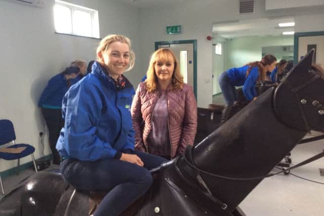 Michelle McIlveen met students using horse riding simulators during a visit to CAFRE Enniskillen. Pictured with CAFRE student Alice Kavanagh.