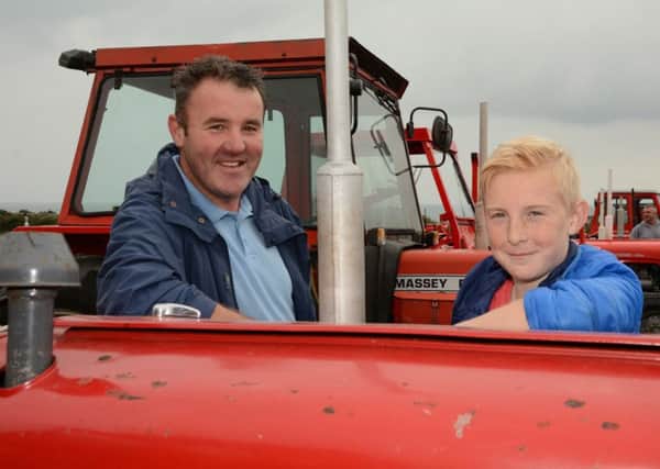 Stephen McVeigh with son Jack, joined the line up of Massey Ferguson tractors at the Lower Mourne Vintage Club Rally, with their original 1968, 35 example.. Picture: Gary Gardiner.
