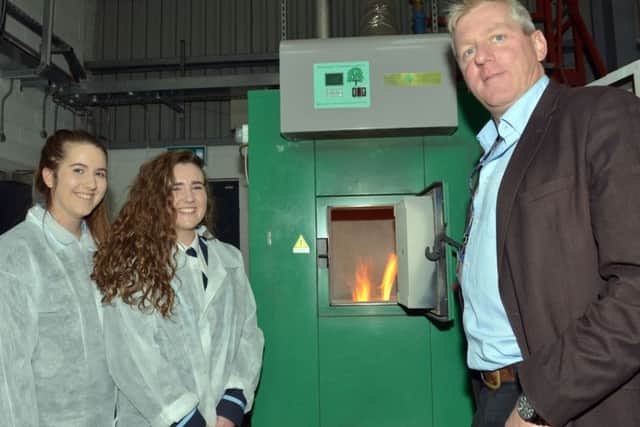 Lydia Poots and Sophie Thompson (Dromore High School) with Chris Johnston (AFBI) at the boiler which provides hot water for the Hillsborough site from burning renewable willow woodchip