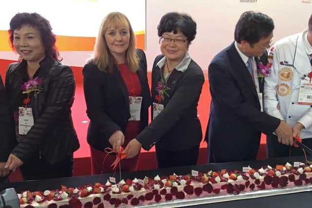 DAERA Minister Michelle McIlveen cuts 20 metre long cake at opening of 20th Food Hotel China exhibition during her agri-trade visit to Shanghai.