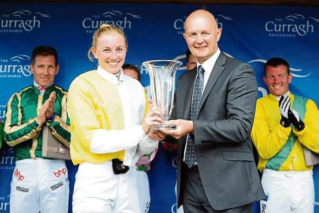 Alice Kavanagh receives the winners trophy from Curragh Racecourse CEO Derek McGrath after her win in the second Corinthian Challenge race on 17 July.