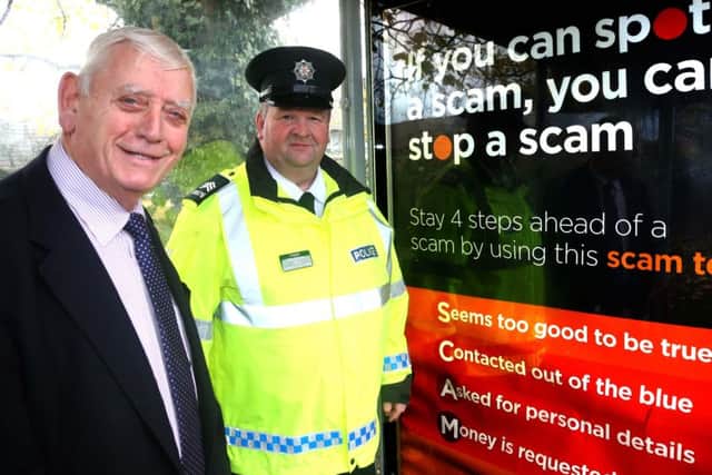 Causeway Coast and Glens Policing and Community Safety Partnership Chairman, Alderman William King and Sergeant Terry McKenna, show their support for the ScamwiseNI campaign. Picture: Kevin McAuley/Multimedia