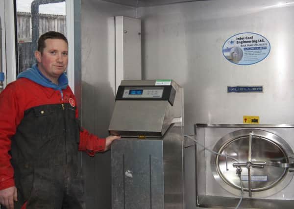 Stephen Morrison, Armoy, checks the Mueller milk silo's MIII control unit which is housed inside the dairy in a stainless steel alcove.