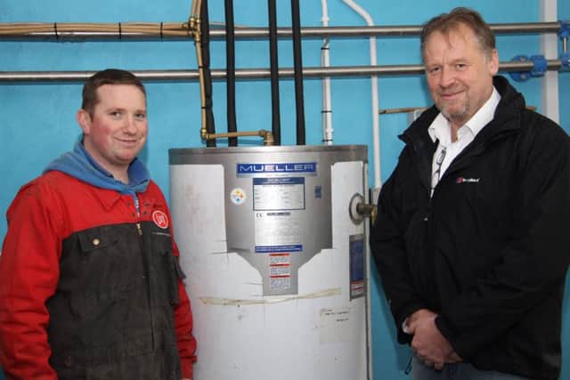 Mueller agent Cecil Wilson, Wilson Milk Tanks, discusses the energy saving benefits of the Mueller Fre-Heater with Armoy dairy farmer Stephen Morrison.