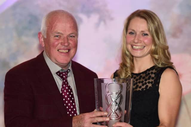 Kim Steele Nicholson receives the Victor Woods Trophy for her outstanding work as a young breeder in the NI Limousin Club. Congratulating Kim is the NI Limousin president Jim Quail