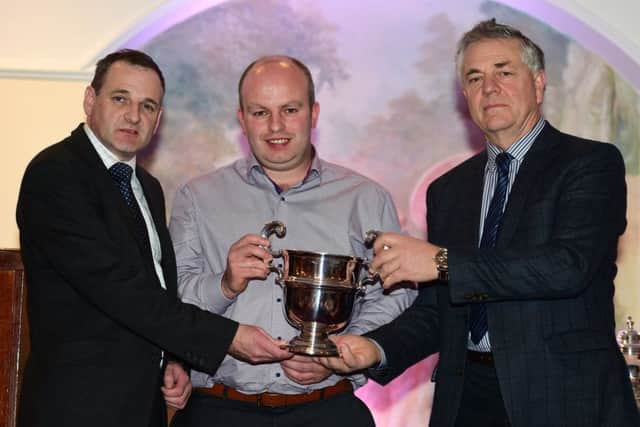 Jeremy Aiken, Dromara, receives the Derriaghy Cup for Carnew Legend on behalf of J and J Aiken from David McCammond, Greenmount Store and Andrew Hyde, Hydes Feeds
