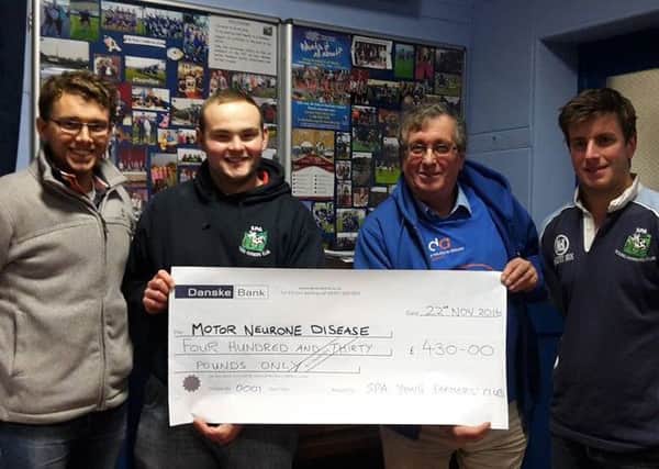 George Shaw, David Young and Thomas Annett handing over the cheque to Motor Neurone Disease Association