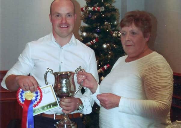 Mr James McClintock, Glenwherry, receiving the Knockavoe Cup for champion Kerry Hill flock 2016 from Mrs Pam Chilman