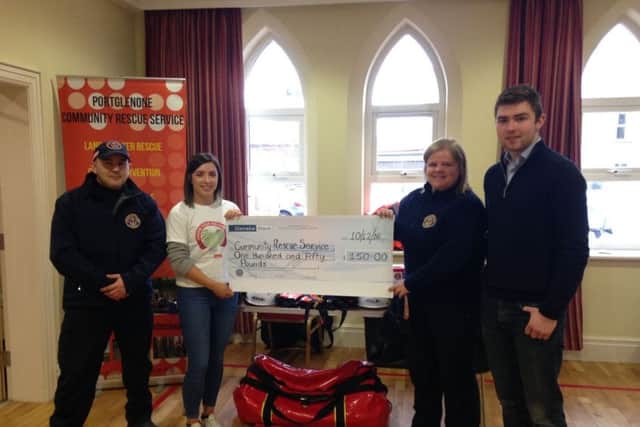 Club leader Davy Graham and club secretary Rachel Barr donating a cheque to Community Rescue Service Portglenone at the club's annual christmas coffee morning
