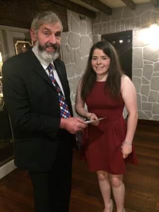 Ballycastle and Rural Riding Community chairman Patrick Trainor is pictured handing over a sponsorship cheque to Hannah Thompson