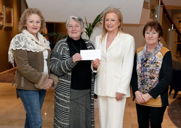 Saintfield Christmas charity ride Organiser Joan Cunningham presents a cheque to Valerie Morrison (PDSA) in the Crowne Plaza Hotel Belfast last Thursday evening, also in the picture are from left Lorraine Johnston and Vi Patterson