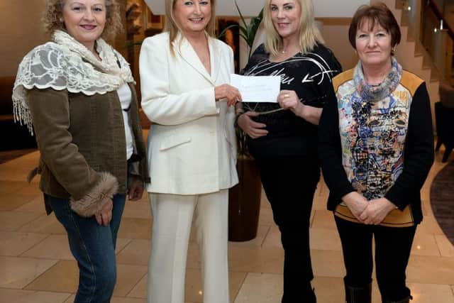 Saintfield Christmas charity ride organiser Joan Cunningham presents a cheque to Angela Cartright (Alzheimer's Society) in the Crowne Plaza Hotel Belfast last Thursday evening, also in the picture are from left Lorraine Johnston and Vi Patterson
