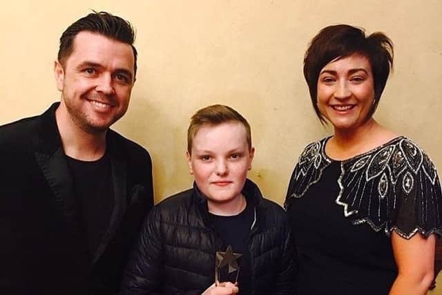 Sean Kane, Kilraughts YFC, is pictured with YFCU president Roberta Simmons and presenter Pete Snodden