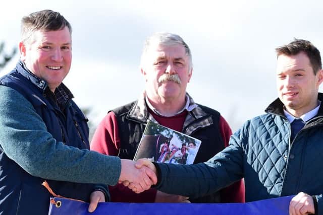 Raymond Pogue of the Elite breeders and Wilbert Steen from Greenmount college congratulate Matthew Donaghy who won the students judging competition