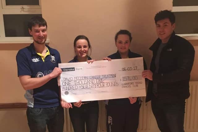 Glarryford YFC members presenting the cheque from the big breakfast and car wash to Chris McClean for David McClean from the Cancer Treatment Fund