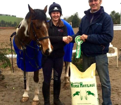 Winner of the 1m class Nikki Cullen pictured here with Tango Lad receiving her prize from Eric Pele