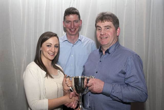 Brendan Butler receives his trophy for Wholework from Grace Cassley with Society Secretary Sean McAllister looking on.
