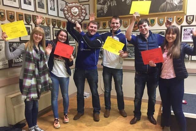 Randalstown YFC members collecting various prizes at Co Antrim YFC AGM