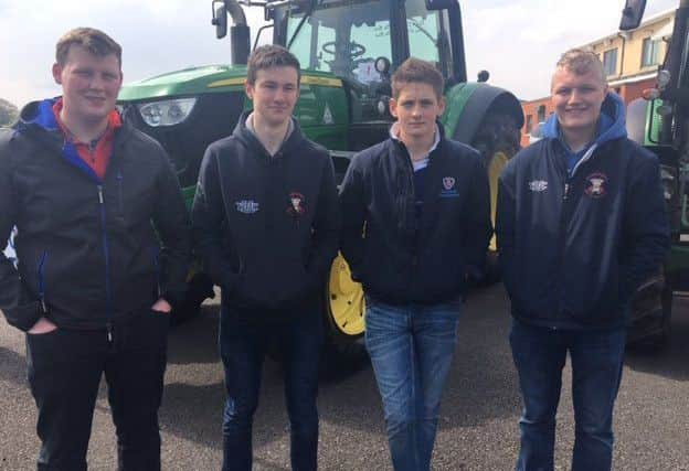 Glenn McKinley, Ryan Armstrong,  Adam Hawkes and Phillip Rainey watching the tractor arrive to the Tyrone  Farming Society Showgrounds