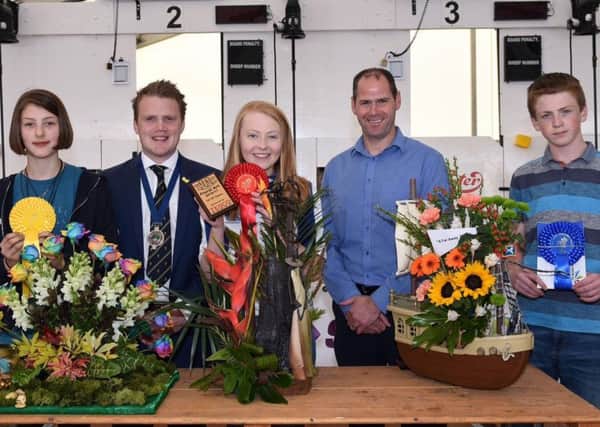Pictured are the 12-14 age category winners in the YFCU floral art competition. From left-right: Third place winner, Erin Warden, Newtownards YFC, YFCU president James Speers, first place winner, Emma Mills, Randalstown YFC, Stephen McGill, commercial manager from sponsor, Tesco NI, and second place winner, James Johnston from Kesh YFC
