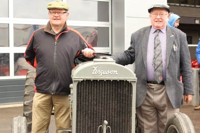 A little grey 1938 Ferguson Brown Type A, that went for Â£24,500. Pictured with Cecil Murphy (left) the new owner