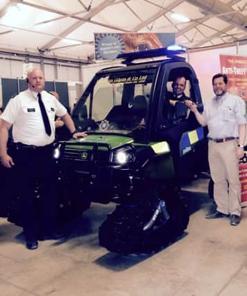 PSNI superintendent Sean Wright takes the keys of the specially liveried John Deere Gator utility vehicle (aka the Copagator) from Randal McConnell of John Deere dealer Johnston Gilpin & Co (right), with Constable Ricky Taylor (left) looking on.